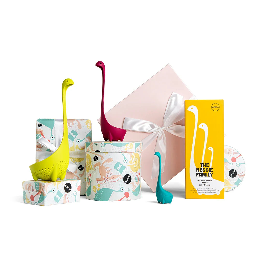 Uncover the vibrant Nessie Family kitchen gadgets, packaged in a ribboned gift box.