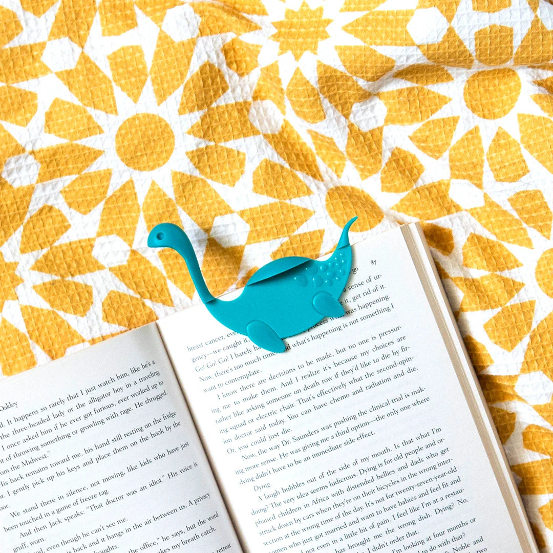 Open your book with Nessie Tale on a yellow and white floral-patterned surface.