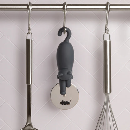 The OTOTO Kitty-Cut pizza cutter hangs on a rod, surrounded by kitchen utensils.