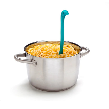 A blue Papa Nessie rests in a pot of cooked spaghetti.