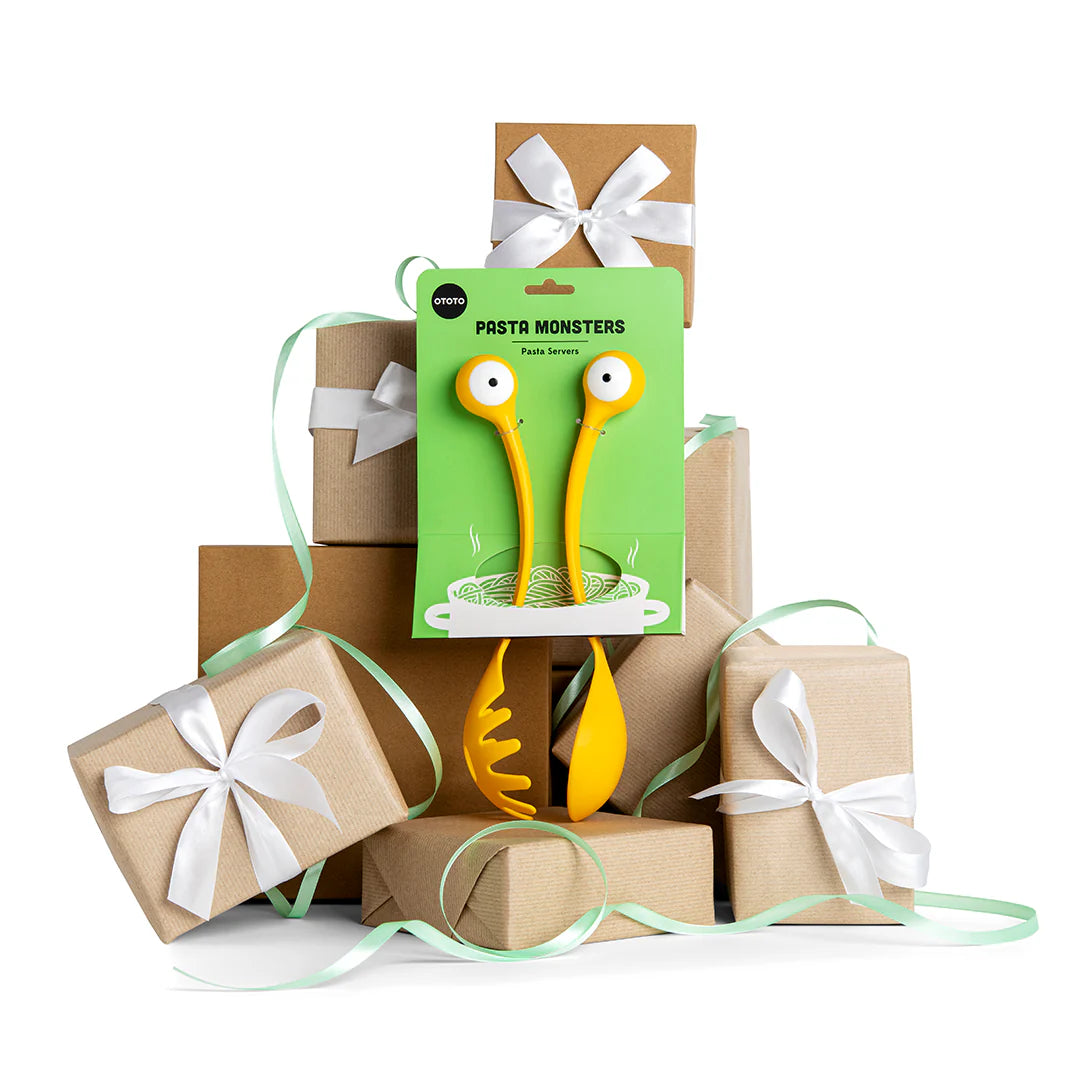 Pasta Monsters on green OTOTO packaging, stacked on gifts with white ribbons and light green curls.