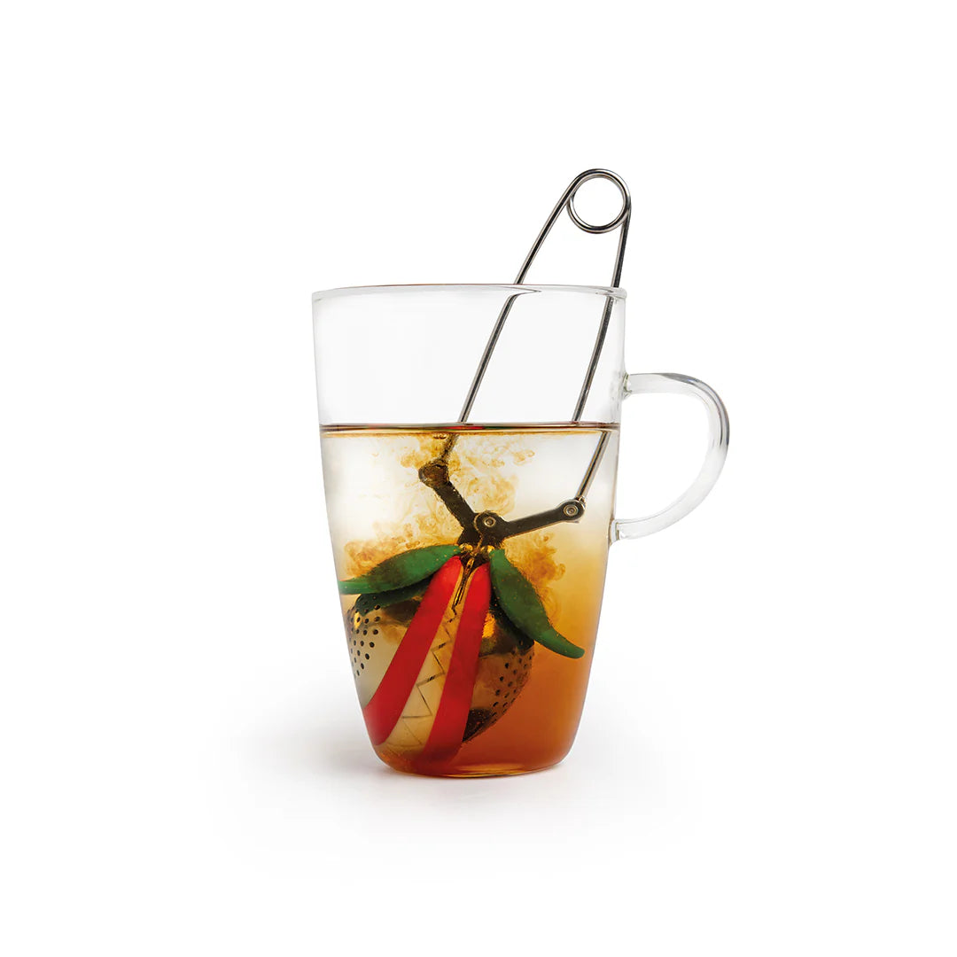 Transparent mug with the Tea Trap by OTOTO inside, steeping and swirling the fragrant brew.